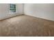 Neutral bedroom showcases a carpeted floor and a window for natural light at 120 Madison Grace Ave, Mcdonough, GA 30252