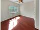 Sunlit bedroom with a ceiling fan and hardwood floors at 120 Madison Grace Ave, Mcdonough, GA 30252