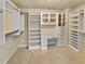 Custom closet with built in shelves, cabinets and a desk area at 120 Madison Grace Ave, Mcdonough, GA 30252