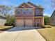 Charming brick two-story home with a two-car garage and well-maintained front yard at 120 Madison Grace Ave, Mcdonough, GA 30252