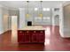 Bright open-concept living room with a fireplace, large windows, hardwood floors and a kitchen island at 120 Madison Grace Ave, Mcdonough, GA 30252