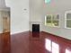 Bright living room with high ceilings, a fireplace, and large windows at 120 Madison Grace Ave, Mcdonough, GA 30252