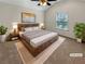 Cozy staged main bedroom with a ceiling fan, natural light, and minimalist decor at 120 Madison Grace Ave, Mcdonough, GA 30252