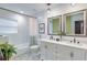 Elegant bathroom featuring double sinks, patterned tile floor, and a bathtub with subway tile surround at 2344 Belmont Dr, Decatur, GA 30032