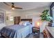 This is a cozy bedroom with a ceiling fan, large plant, and dark wood floors at 2344 Belmont Dr, Decatur, GA 30032