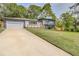 Stylish two-story home featuring a lush green lawn and long driveway at 2344 Belmont Dr, Decatur, GA 30032
