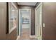 Hallway with dark accent wall providing a view of the home office space and a bathroom at 2344 Belmont Dr, Decatur, GA 30032