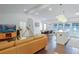Bright, open-concept living space with hardwood floors and modern lighting, flowing into dining and kitchen areas at 2344 Belmont Dr, Decatur, GA 30032