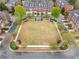 Community square with a lawn and bordered by homes and streets in the neighborhood at 4908 Waters Edge Trl, Roswell, GA 30075