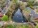 Aerial view of a peaceful pond, surrounded by lush trees and neighborhood residences at 4908 Waters Edge Trl, Roswell, GA 30075