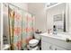 Bright bathroom featuring a vanity with storage, mirror, and a colorful shower curtain at 4908 Waters Edge Trl, Roswell, GA 30075