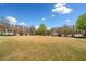 A picturesque view of the community green surrounded by charming townhomes and lush landscaping at 4908 Waters Edge Trl, Roswell, GA 30075
