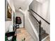 Hallway featuring tiled floor, a staircase with black and white runner, and neutral paint at 4908 Waters Edge Trl, Roswell, GA 30075