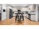 Spacious kitchen with white cabinets, dark countertops, stainless steel appliances, and a central island with seating at 4908 Waters Edge Trl, Roswell, GA 30075