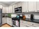 Well-appointed kitchen featuring sleek, stainless-steel appliances, granite countertops, and ample cabinet space at 4908 Waters Edge Trl, Roswell, GA 30075