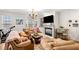 Cozy living room with a fireplace, built-ins, large windows, and comfortable seating at 4908 Waters Edge Trl, Roswell, GA 30075