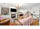 Open-concept living room featuring hardwood floors, a fireplace, and built-in shelving at 4908 Waters Edge Trl, Roswell, GA 30075