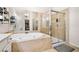 Relaxing main bathroom with a soaking tub, glass shower, and tile flooring at 4908 Waters Edge Trl, Roswell, GA 30075