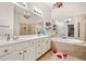 Main bathroom features dual sinks, a soaking tub, and a glass-enclosed shower for convenience at 4908 Waters Edge Trl, Roswell, GA 30075