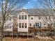 A multi-level rear exterior view showing deck, patio, and natural surroundings at 4908 Waters Edge Trl, Roswell, GA 30075