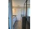 Bathroom featuring a glass shower door, double sinks, white cabinets, and grey tiled floors at 95 Kendall Ln, Covington, GA 30014