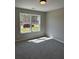 Bedroom with neutral walls, carpet flooring, and a window providing ample natural light at 95 Kendall Ln, Covington, GA 30014