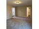 Bedroom with neutral walls, carpet flooring, and two doorways offering ample natural light at 95 Kendall Ln, Covington, GA 30014
