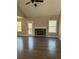 Spacious living room with a stone fireplace, hardwood floors, and natural light from large windows at 95 Kendall Ln, Covington, GA 30014