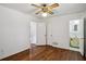 This bedroom features hardwood floors, a ceiling fan, two closets, and access to an ensuite bathroom at 3712 Spring Hill Se Rd, Smyrna, GA 30080