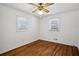 Bright bedroom with two windows, ceiling fan, and beautiful hardwood floors at 3712 Spring Hill Se Rd, Smyrna, GA 30080