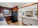 Spacious kitchen with breakfast bar connecting to brick fireplace living room at 3712 Spring Hill Se Rd, Smyrna, GA 30080