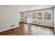 Spacious living room with hardwood floors, white walls, and large windows at 3712 Spring Hill Se Rd, Smyrna, GA 30080