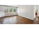 Bright living room with hardwood floors, large windows, and white walls at 3712 Spring Hill Se Rd, Smyrna, GA 30080