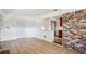 Tile floored living room with kitchen view, brick accent wall, and closet at 3712 Spring Hill Se Rd, Smyrna, GA 30080