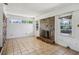 Sunlit living room with brick fireplace, multiple windows, and tile floor at 3712 Spring Hill Se Rd, Smyrna, GA 30080