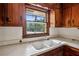 Double sink under a window with wooden trim and overhead cabinets in the kitchen at 3712 Spring Hill Se Rd, Smyrna, GA 30080