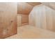 Attic space with unfinished plywood walls and flooring, offering potential for customization at 4385 Old Hamilton Mill Rd, Buford, GA 30518