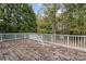 Spacious back deck with white railings, overlooks lush trees and foliage at 4385 Old Hamilton Mill Rd, Buford, GA 30518