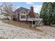 Two-story brick home with deck and stairs in landscaped backyard at 4385 Old Hamilton Mill Rd, Buford, GA 30518