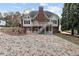 The back exterior with a brick patio and wooden deck at 4385 Old Hamilton Mill Rd, Buford, GA 30518