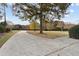 Scenic view of a concrete path and a gazebo surrounded by lush greenery and trees in a serene backyard setting at 4385 Old Hamilton Mill Rd, Buford, GA 30518
