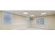 Basement area with three windows, beige walls and white trim at 4385 Old Hamilton Mill Rd, Buford, GA 30518