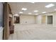 Spacious finished basement with open floor plan, neutral carpet and access to other rooms at 4385 Old Hamilton Mill Rd, Buford, GA 30518