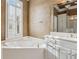 Bathroom with a corner garden tub, shutters, vanity, and view in the mirror of a walk-in shower at 4385 Old Hamilton Mill Rd, Buford, GA 30518
