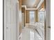 Bright, elegant bathroom featuring dual sinks, garden tub and white tile floor at 4385 Old Hamilton Mill Rd, Buford, GA 30518