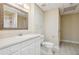 Full bathroom with white vanity, toilet, and framed mirror at 4385 Old Hamilton Mill Rd, Buford, GA 30518