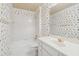Charming bathroom featuring sailboat-themed wallpaper, white cabinets, and bathtub with shower at 4385 Old Hamilton Mill Rd, Buford, GA 30518