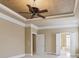 Spacious bedroom features a ceiling fan, tray ceiling and decorative molding throughout the room at 4385 Old Hamilton Mill Rd, Buford, GA 30518