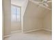 Bright bedroom with sloped ceilings, plush carpeting, ceiling fan, and a shuttered window at 4385 Old Hamilton Mill Rd, Buford, GA 30518