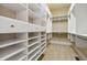 Well-organized walk-in closet with custom shelving and ample storage space for clothing and accessories at 4385 Old Hamilton Mill Rd, Buford, GA 30518